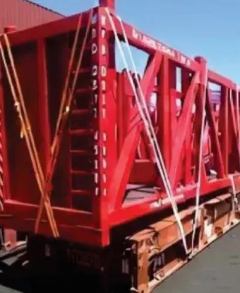 Red steel frame of a flat-rack container secured with lashing straps